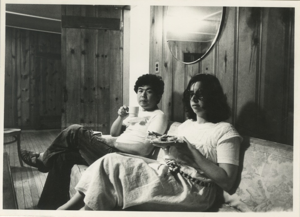 Arakawa and Madeline eating on a couch